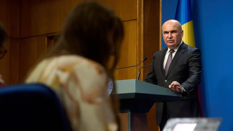 Ilie Bolojan taie de la Educație ca să dea bani la partide. Rectificare cu dedicație pentru clasa politică, în timp ce românii strâng cureaua 