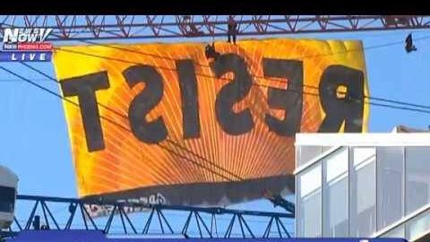 Greenpeace a agățat o pancartă cu #REZIST de o macara în timpul vizitei lui Trump la Bruxelles