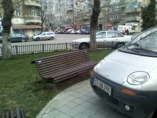 Parcat pe trotuar în faţa unui părculeţ