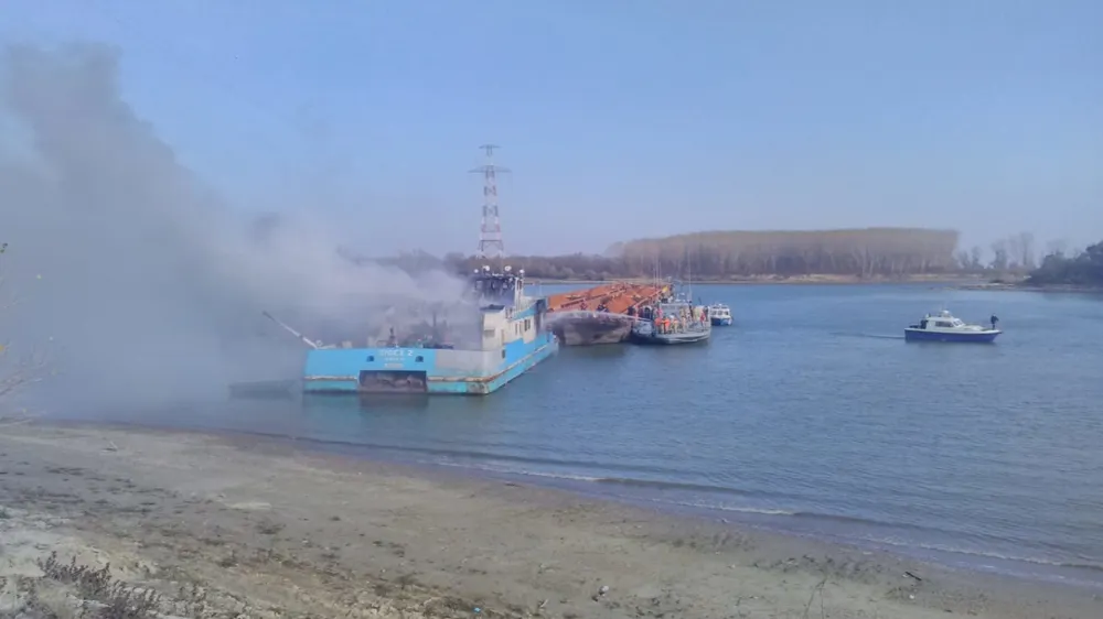 Incendiu pe Dunăre. O navă împingător, cuprinsă de flăcări. Marinarii militari intervin
