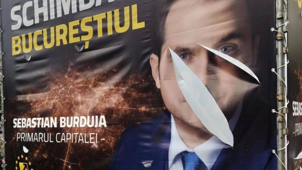 Panou vandalizat cu Sebastian Burduja
