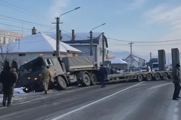VIDEO - Transportator miliar cu platformă pentru tancuri, accident pe o șosea din Bistrița-Năsăud