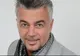 Schimbare radicală pentru Adrian Enache: şi-a lăsat plete şi s-a rujat