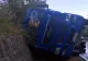 FOTO | TIR plin cu bușteni, răsturnat într-o curbă periculoasă, în Bistrița-Năsăud